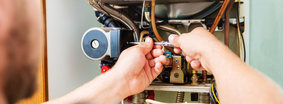 Technician repairing furnace unit.