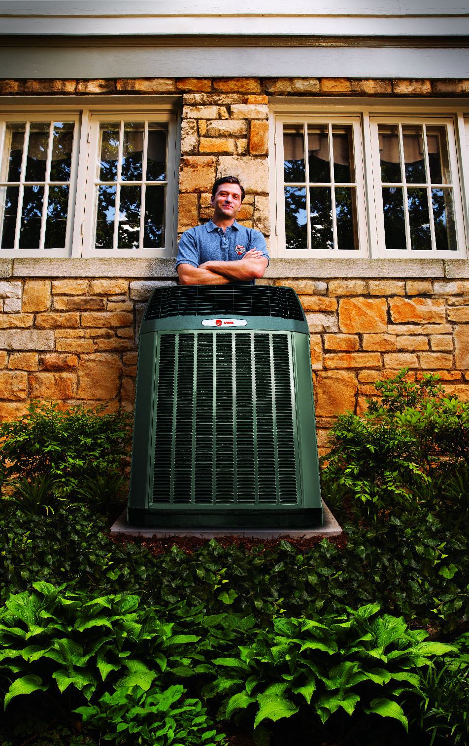 Trane technician behind hvac unit