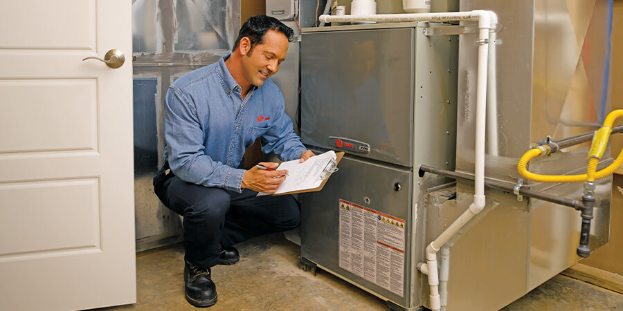 Service technician inspecting heater
